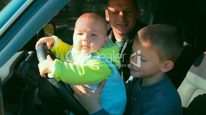 father and two sons in the car