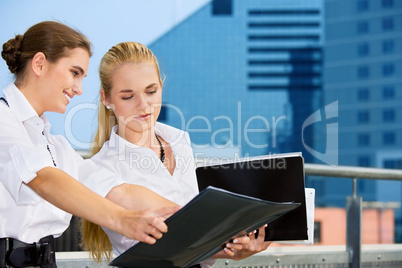 two happy businesswomen with documents