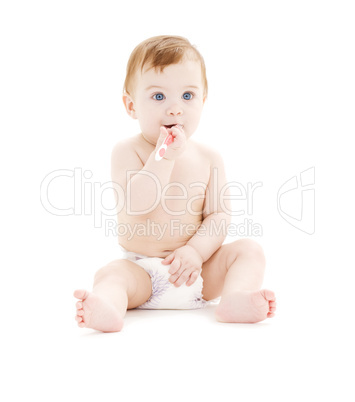 baby boy in diaper with toothbrush