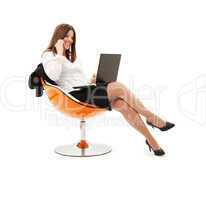 businesswoman in chair with laptop and phone