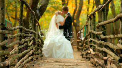 bride and groom at the wooden bridge