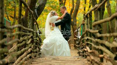 bride and groom on old bridge