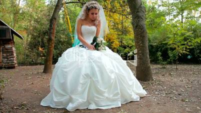 bride on a swing in the autumn park