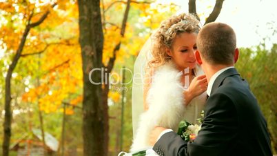 bride and groom in autumn park