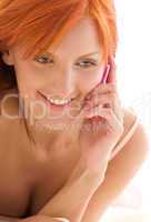 happy redhead woman with cell phone