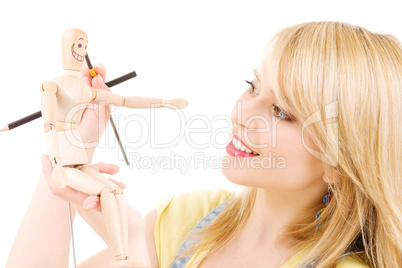 happy teenage girl with wooden model dummy