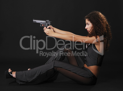 Sexy gangster shooting a handgun.