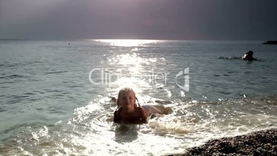 little girl on the sunset beach