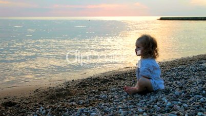 little girl on the sunset beach
