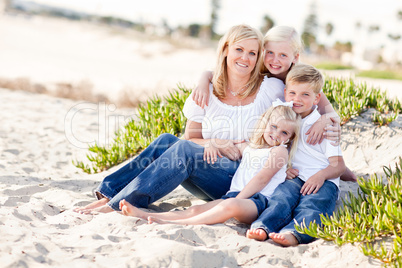 Attractive Mom and Her Cute Children at The Beach