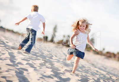 Adorable Brother and Sister Having Fun at the Beach