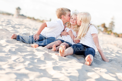 Adorable Sibling Children Kissing the Youngest