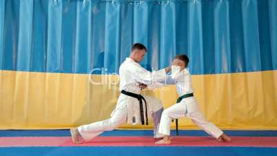 Boy learning from his karate instructor