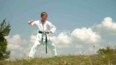 boy practicing karate on the nature
