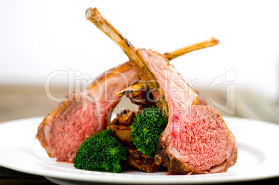 Roasted Rack of Lamb herb crusted on a white plate