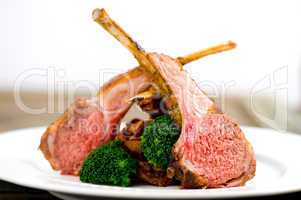 Roasted Rack of Lamb herb crusted on a white plate