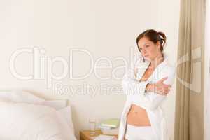 Morning bedroom - woman in bathrobe and bra
