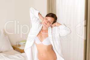 Morning bedroom - woman in bathrobe and bra