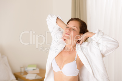 Morning bedroom - woman in bathrobe and bra