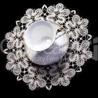 small lacy doily with  cup
