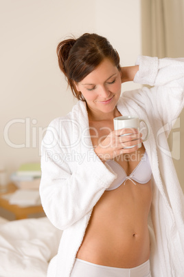 Morning bedroom - woman in bathrobe with coffee