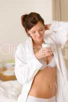 Morning bedroom - woman in bathrobe with coffee