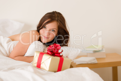 Bedroom surprise present - young happy woman