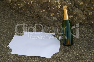 Blank postcard and champagne bottle