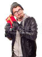 Warmly Dressed Young Man Holding Wrapped Gift To His Ear