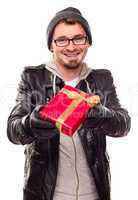 Warmly Dressed Young Man Handing Wrapped Gift Out