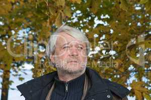 Portrait of middle-aged man in autumn day.