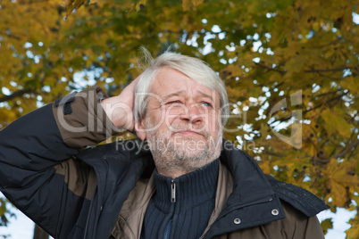 Portrait of middle-aged man in autumn day.