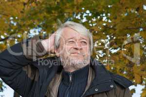 Portrait of middle-aged man in autumn day.