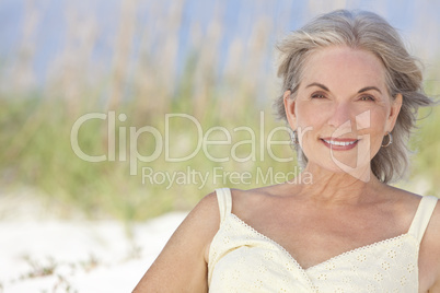 Attractive Elegant Senior Woman Sitting At A Beach