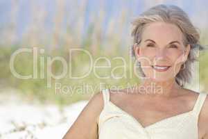 Attractive Elegant Senior Woman Sitting At A Beach