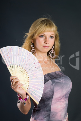 Beautiful young woman with fan