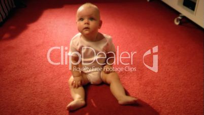 Child sits on the carpet