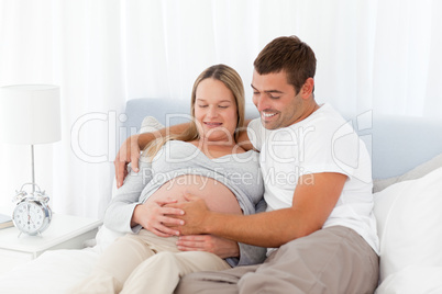 Future parents resting in the bedroom