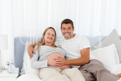 Attentive man touching the belly of his wife
