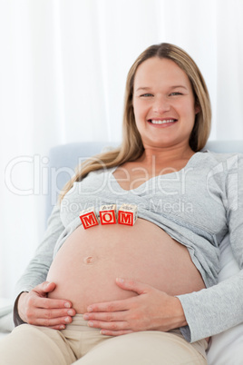 Adorable woman with mom letters on the belly