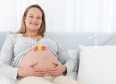 Happy future mom having cubes on her belly