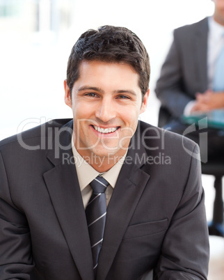 Happy businessman in the foreground during a meeting with a frie