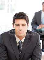 Serious businessman during an interview with a co-worker