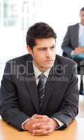 Thoughtful businessman during a meeting with a colleague