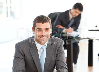 Happy businessman in the foreground during a meeting