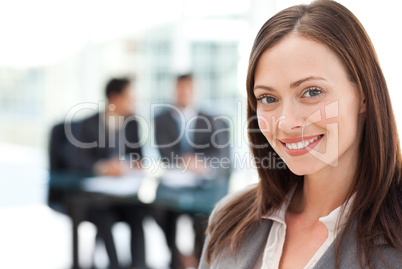 Cheerful businesswoman during a meeting with her two male collea