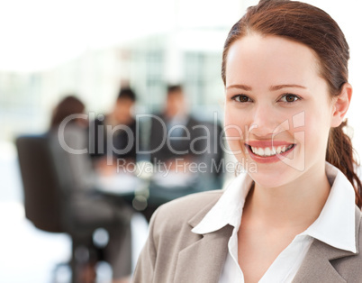Cheerful businesswoman during a meeting with her team