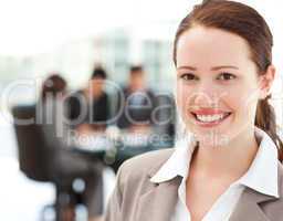 Cheerful businesswoman during a meeting with her team