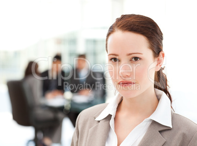 Charismatic businesswoman standing in the foreground while her t