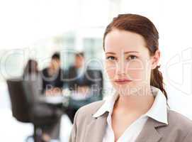 Charismatic businesswoman standing in the foreground while her t